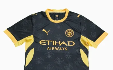 Leaked image of Manchester City's 2026/27 away kit featuring a black shirt with embossed worker bee pattern